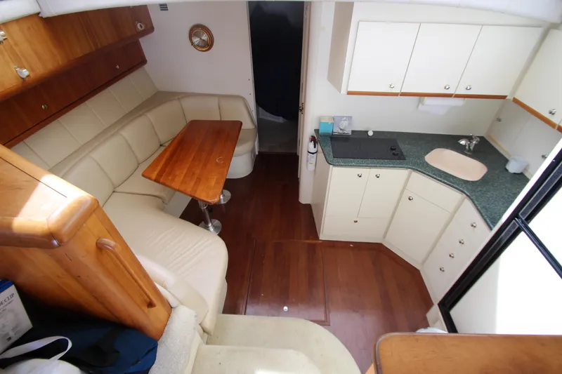 Slide: The Image of Interior of 2000 Silverton 37 Convertible yacht with kitchen and dining area. - 26