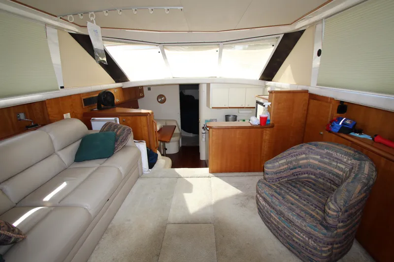 Slide: The Image of Interior of 2000 Silverton 37 Convertible yacht with cozy seating and wooden cabinetry. - 30