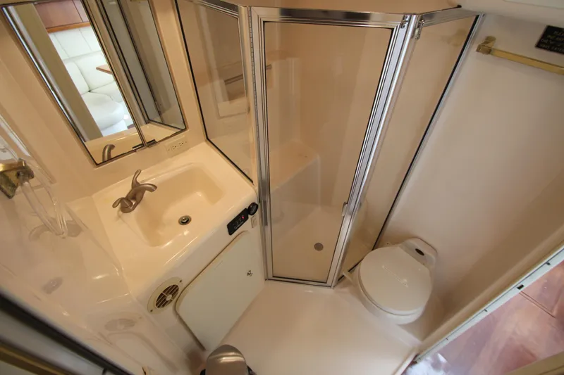 Slide: The Image of Bathroom interior of 2000 Silverton 37 Convertible yacht with shower, sink, and toilet. - 36