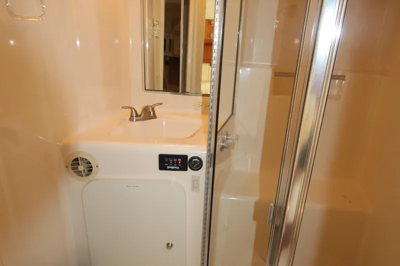 Slide: The Image of Bathroom interior of 2000 Silverton 37 Convertible yacht with sink and shower. - 37