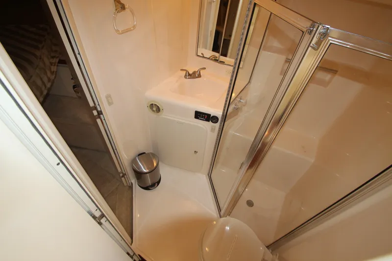 Slide: The Image of Bathroom interior of 2000 Silverton 37 Convertible yacht with shower and sink. - 38