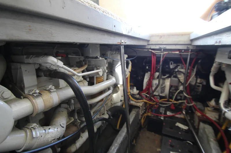 Slide: The Image of Engine room of a 2000 Silverton 37 Convertible boat, showcasing wiring and mechanical components. - 42
