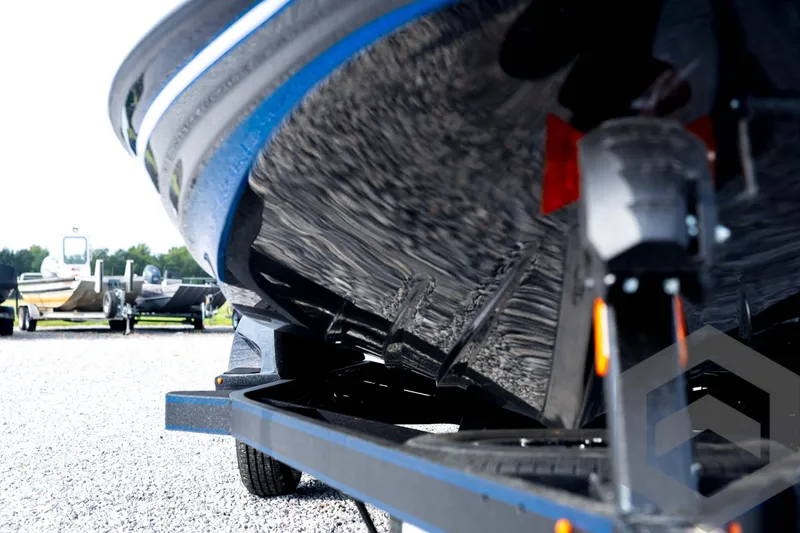 Slide: The Image of 2026 Skeeter FXR21 FLEX boat on trailer, close-up view of hull and trailer details. - 10