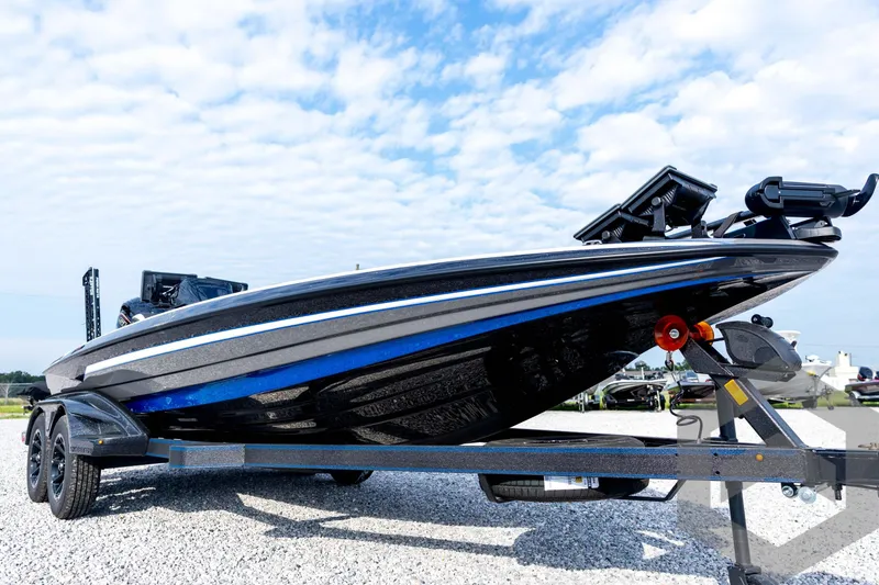 Slide: The Image of 2026 Skeeter FXR21 FLEX boat on trailer, under a partly cloudy sky. - 13