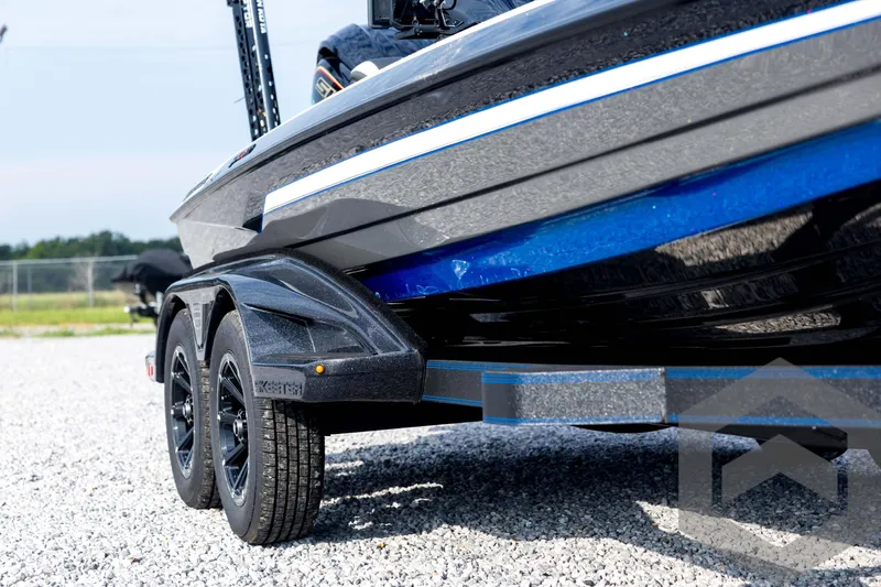 Slide: The Image of 2026 Skeeter FXR21 FLEX boat on trailer, showcasing sleek design and dual wheels. - 14