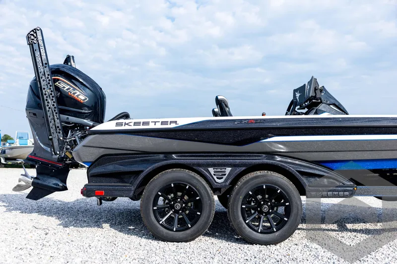 Slide: The Image of 2026 Skeeter FXR21 FLEX boat with powerful engine and sleek design on gravel surface. - 16