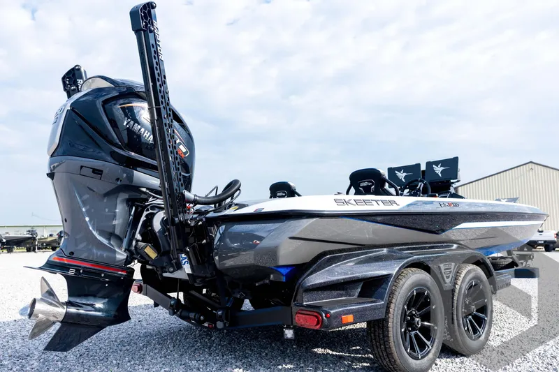 Slide: The Image of 2026 Skeeter FXR21 FLEX boat with Yamaha engine, parked on gravel, showcasing sleek design. - 17