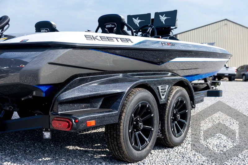 Slide: The Image of 2026 Skeeter FXR21 FLEX boat on trailer, featuring sleek design and dual wheels. - 18