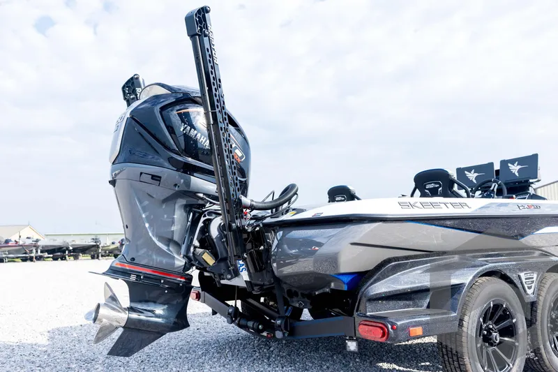 Slide: The Image of 2026 Skeeter FXR21 FLEX boat with Yamaha engine, parked on gravel under a cloudy sky. - 19