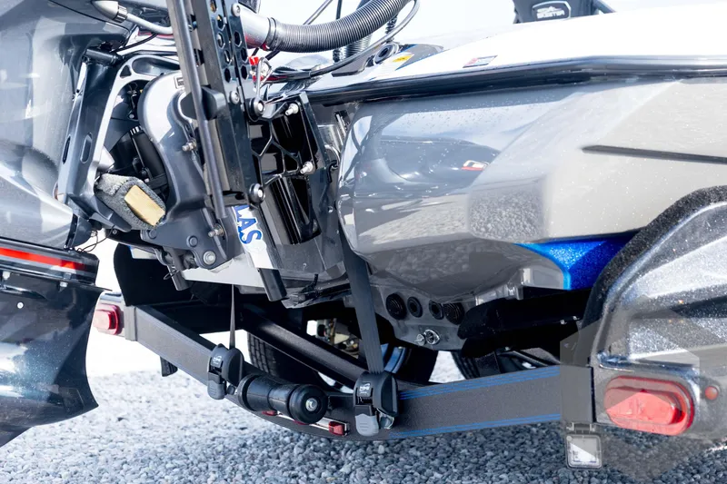 Slide: The Image of 2026 Skeeter FXR21 FLEX boat engine and trailer detail on gravel surface. - 20