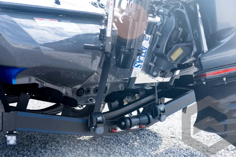 Slide: The Image of 2026 Skeeter FXR21 FLEX boat trailer hitch and motor detail on gravel surface. - 26