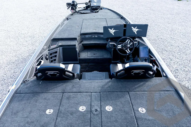 Slide: The Image of 2026 Skeeter FXR21 FLEX boat interior with dual screens and steering wheel, featuring spacious seating. - 43