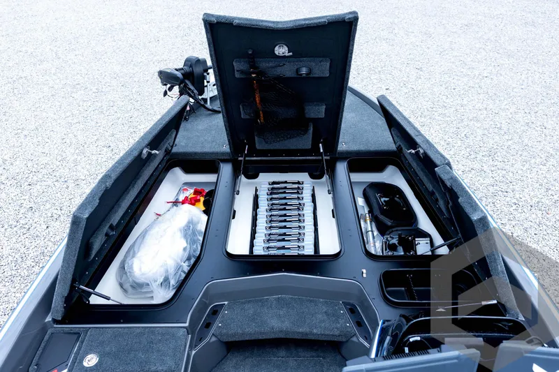Slide: The Image of 2026 Skeeter FXR21 FLEX boat storage compartments with organized fishing gear and equipment. - 49
