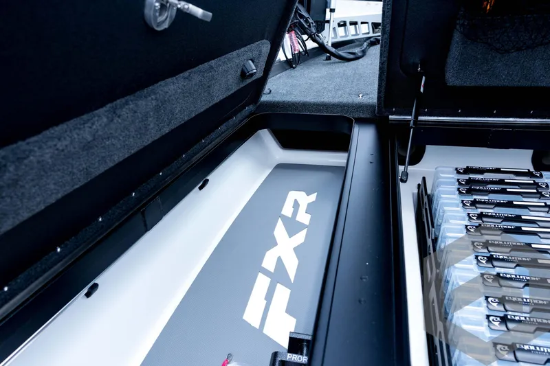 Slide: The Image of 2026 Skeeter FXR21 FLEX boat storage compartment with organized tackle boxes. - 50