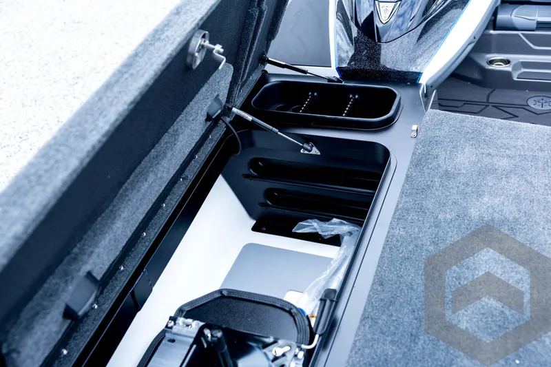 Slide: The Image of 2026 Skeeter FXR21 FLEX boat storage compartment with open lid, showcasing interior design. - 56