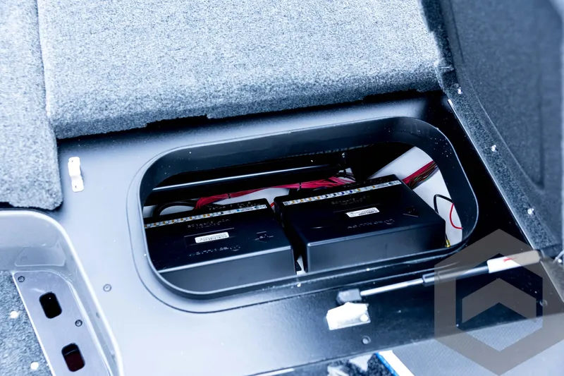 Slide: The Image of 2026 Skeeter FXR21 FLEX boat battery compartment with dual batteries and wiring. - 59