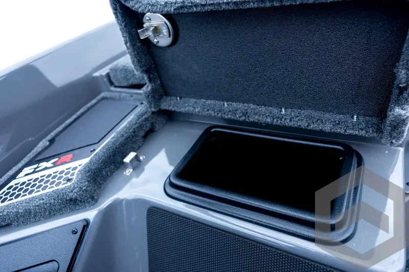 Slide: The Image of 2026 Skeeter FXR21 FLEX boat storage compartment with open lid and secure latch. - 64