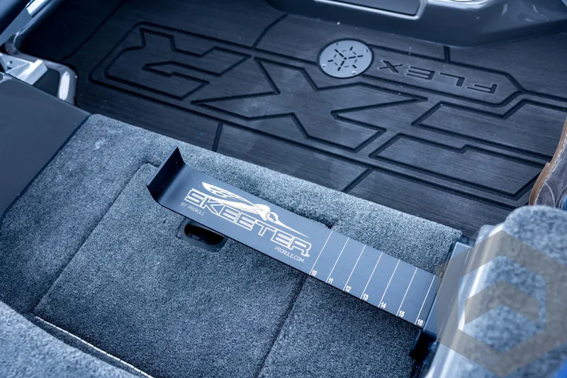Slide: The Image of 2026 Skeeter FXR21 FLEX interior with branded floor mat and measuring tool. - 66
