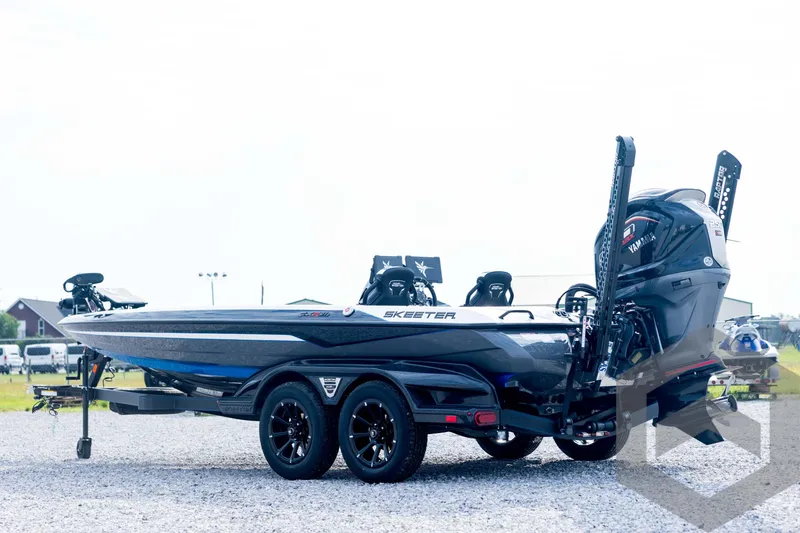 Slide: The Image of 2026 Skeeter FXR21 FLEX boat on trailer, featuring Yamaha engine, parked outdoors. - 7