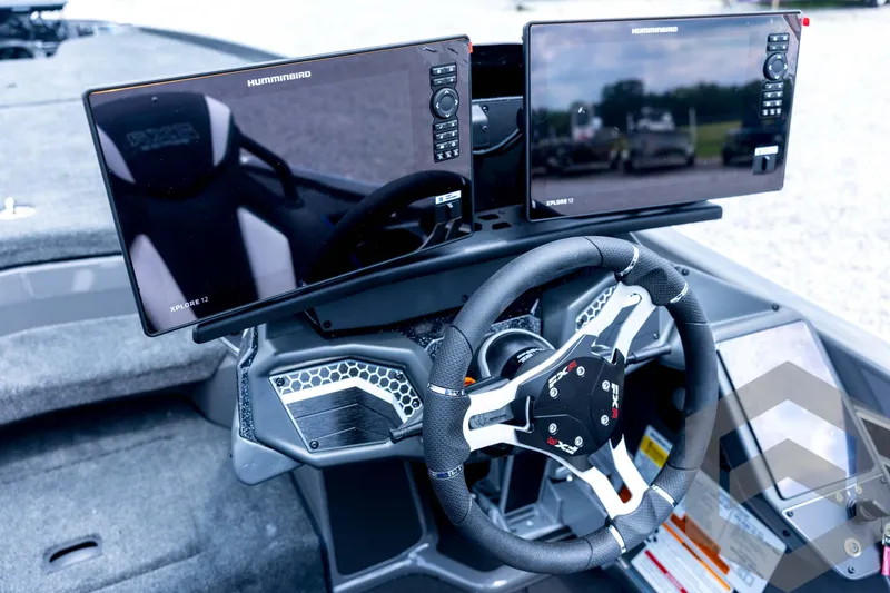 Slide: The Image of 2026 Skeeter FXR21 FLEX boat dashboard with dual Humminbird Xplore 12 displays and steering wheel. - 72