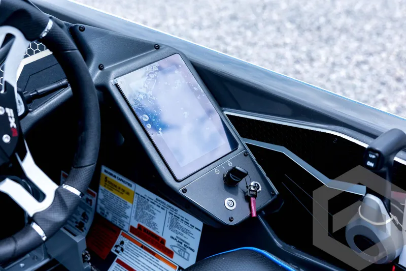 Slide: The Image of 2026 Skeeter FXR21 FLEX boat dashboard with touchscreen and steering wheel. - 73