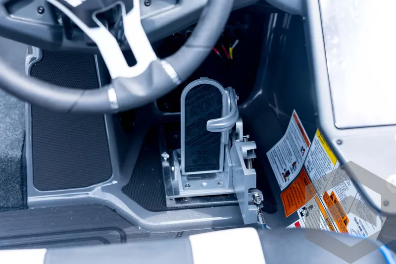 Slide: The Image of 2026 Skeeter FXR21 FLEX boat cockpit with steering wheel and foot pedal controls. - 74