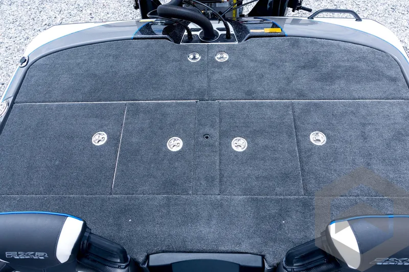 Slide: The Image of 2026 Skeeter FXR21 FLEX boat deck with gray carpet and storage compartments. - 76