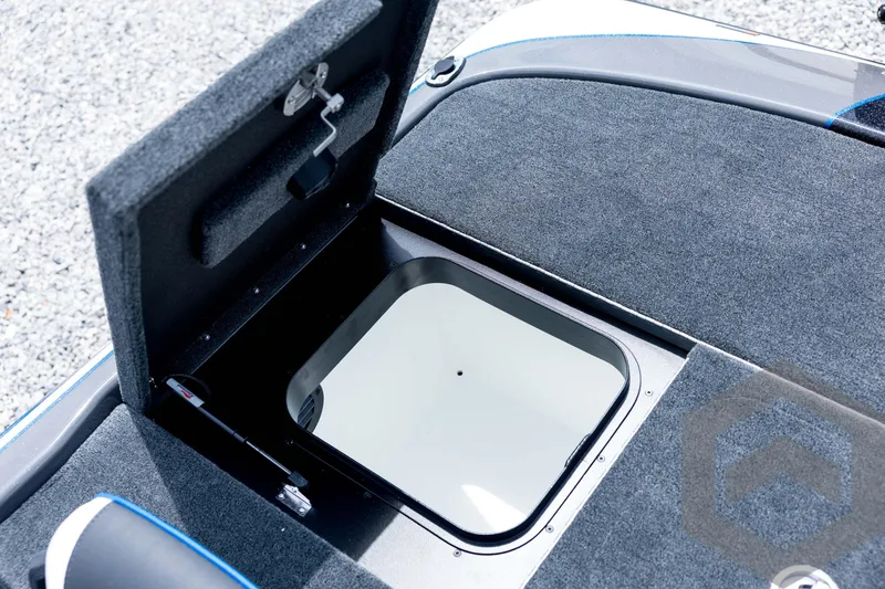 Slide: The Image of 2026 Skeeter FXR21 FLEX boat storage compartment with open hatch, showcasing interior design. - 80