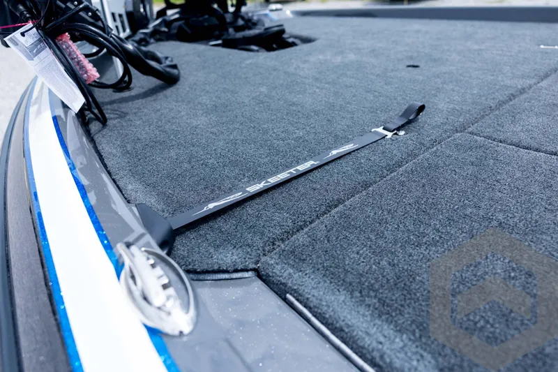 Slide: The Image of 2026 Skeeter FXR21 FLEX boat deck with gray carpet and branded strap. - 83