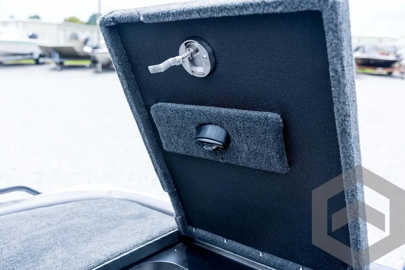 Slide: The Image of 2026 Skeeter FXR21 FLEX boat compartment with lock and carpeted interior. - 84