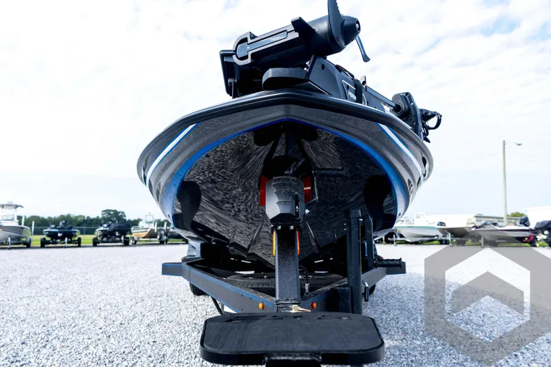 Slide: The Image of 2026 Skeeter FXR21 FLEX boat on trailer, front view, parked on gravel lot. - 9