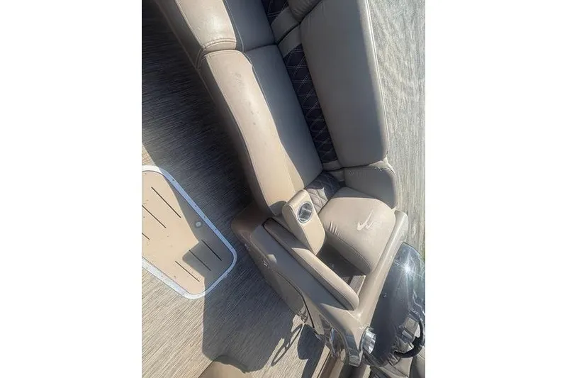 Slide: The Image of 2020 Bennington 25 RSB boat interior with beige seating and cup holder. - 10