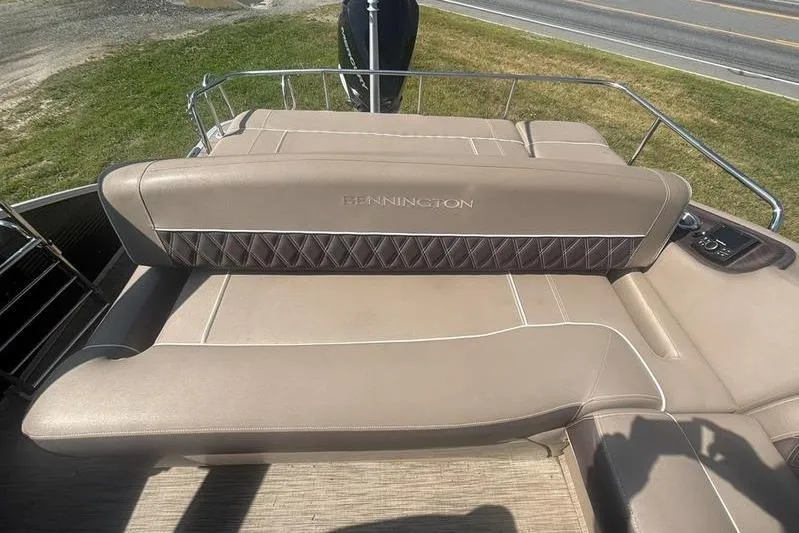 Slide: The Image of 2020 Bennington 25 RSB boat with beige seating and diamond stitching detail. - 17