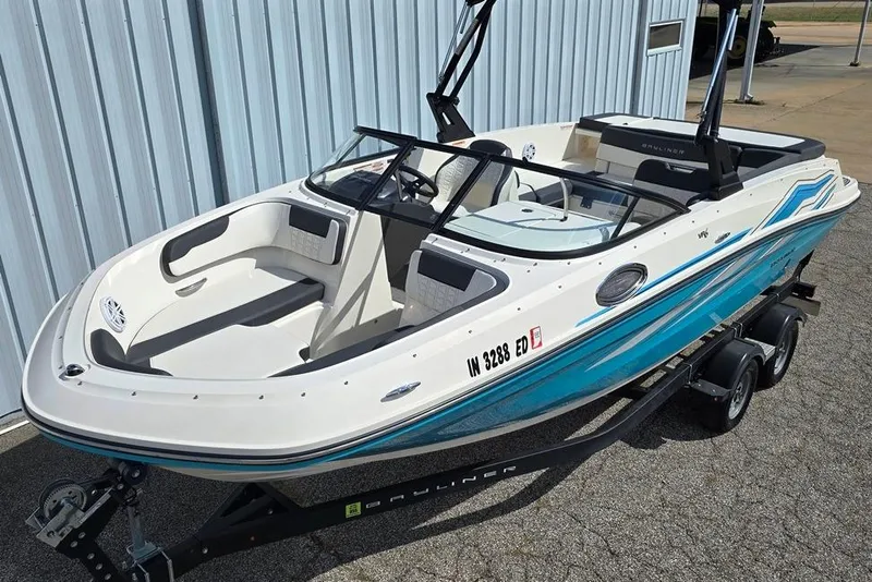 The Image of 2019 Bayliner VR5 Bowrider I/O boat on trailer, parked near a building. - 0