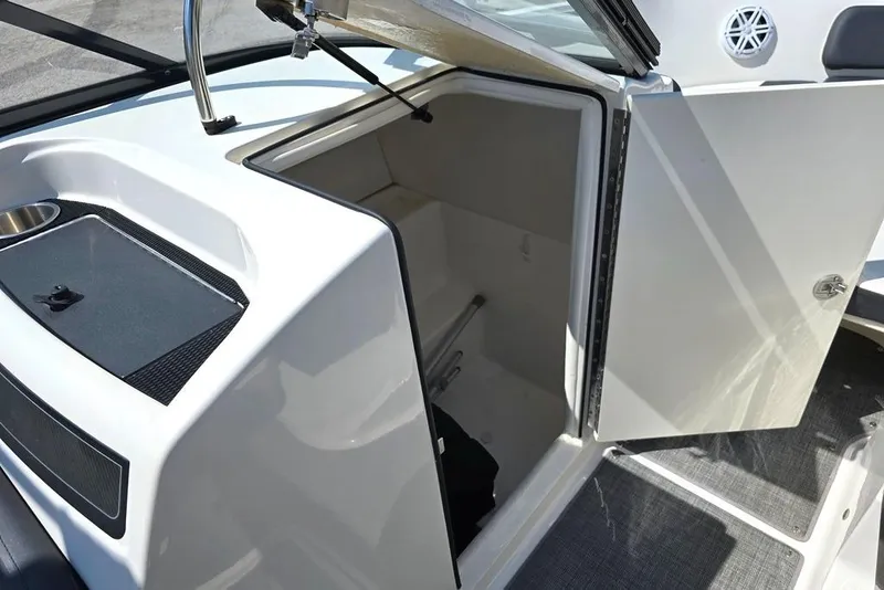 Slide: The Image of 2019 Bayliner VR5 Bowrider I/O boat interior storage compartment with open door. - 10