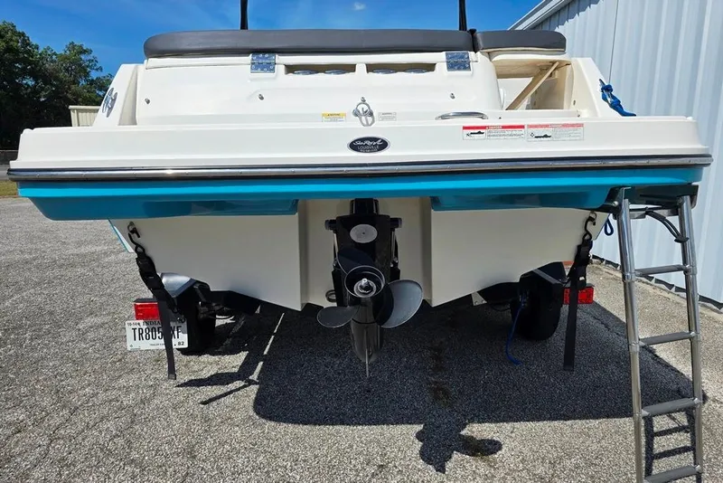 Slide: The Image of 2019 Bayliner VR5 Bowrider I/O boat rear view with propeller and ladder. - 14