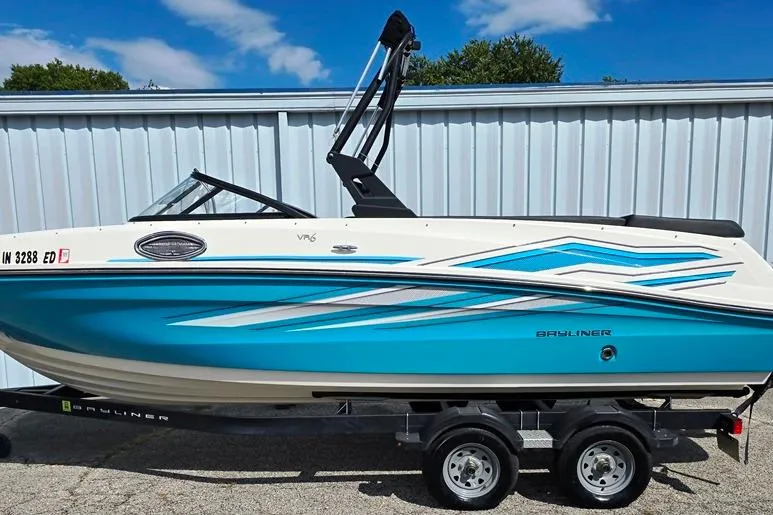 Slide: The Image of 2019 Bayliner VR5 Bowrider I/O boat on trailer, blue and white design. - 22