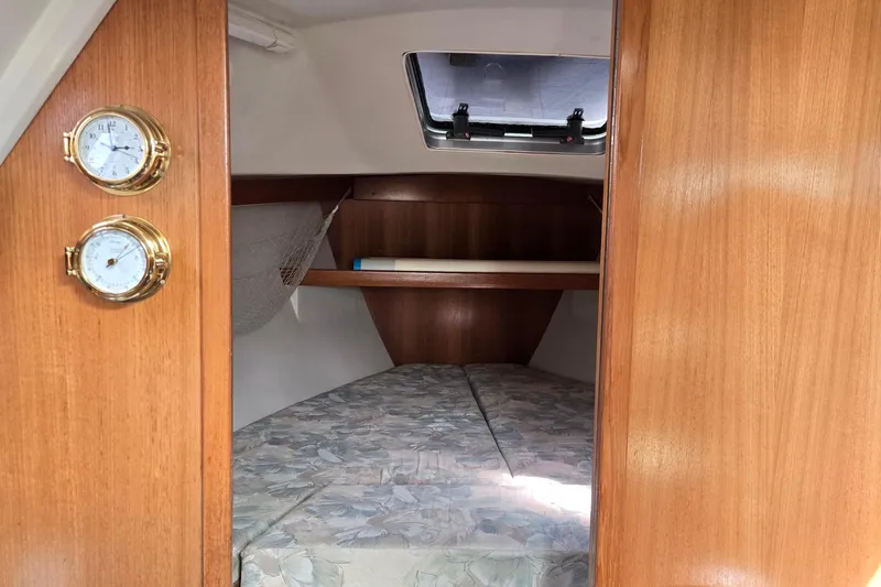 Slide: The Image of 1994 Catalina 34 yacht cabin interior with wooden finish and nautical instruments. - 15
