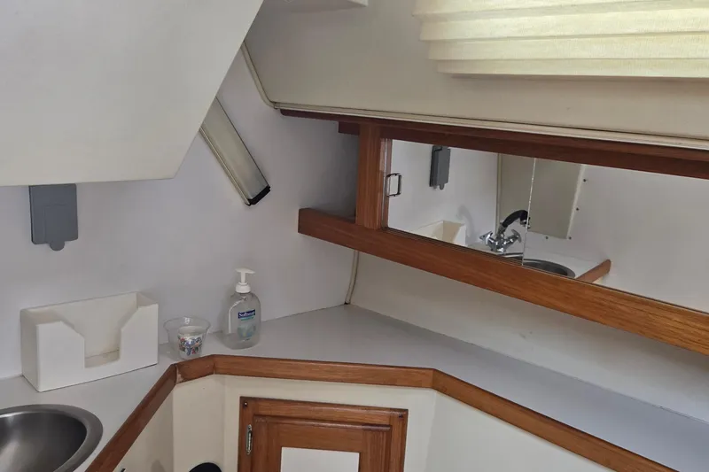 Slide: The Image of Interior of 1994 Catalina 34 yacht bathroom with sink, mirror, and wooden accents. - 20