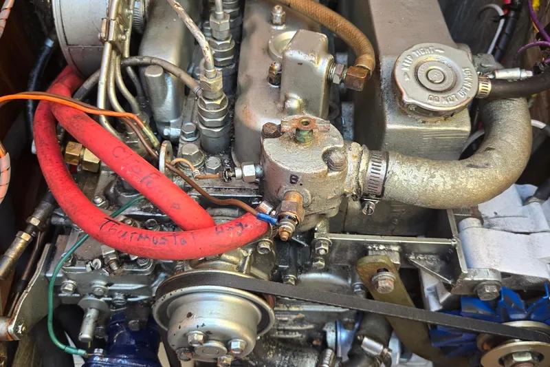 Slide: The Image of Engine of a 1994 Catalina 34 sailboat with visible hoses and components. - 21