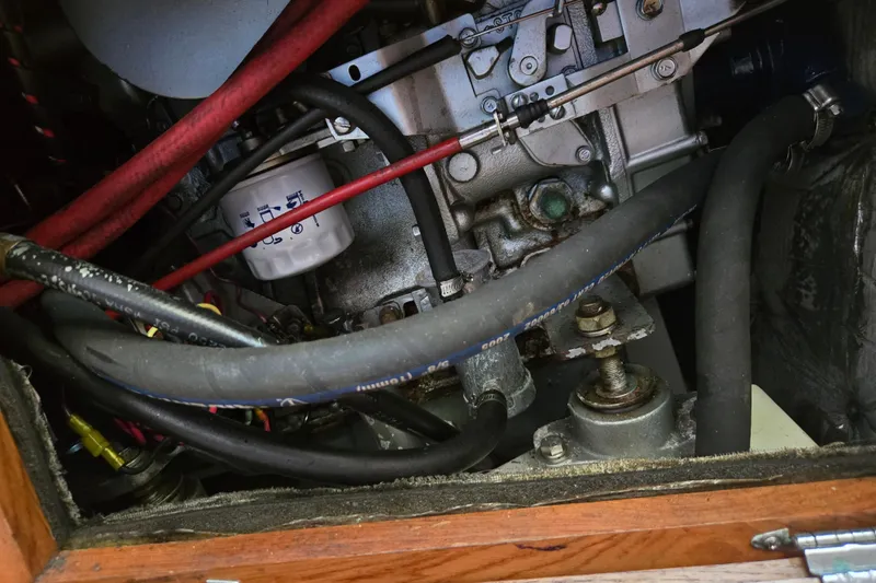 Slide: The Image of Engine compartment of a 1994 Catalina 34 sailboat, showing hoses and mechanical components. - 23