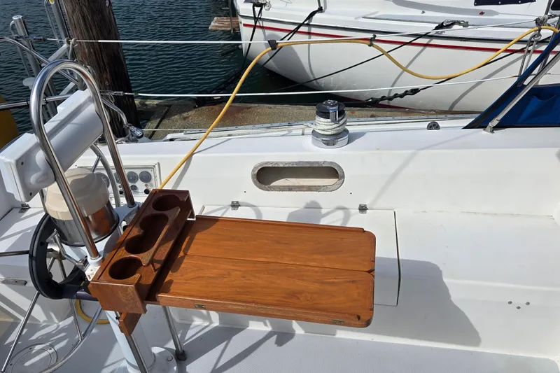 Slide: The Image of Cockpit of 1994 Catalina 34 sailboat with wooden table and steering wheel. - 5