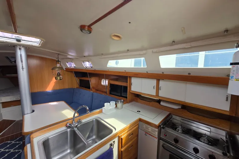 Slide: The Image of Interior of a 1994 Catalina 34 sailboat with kitchen and seating area. - 7