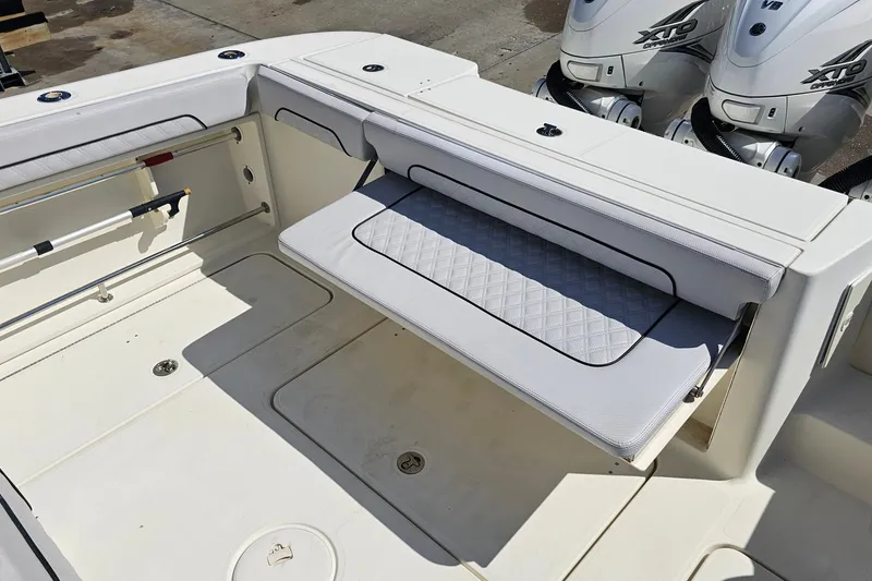 Slide: The Image of 2008 Hydra-Sports Vector 3500 VX boat interior with foldable seating and dual outboard engines. - 25