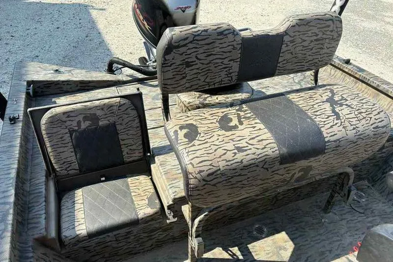 Slide: The Image of 2020 Xpress H20B Bay boat interior with camouflage seating and motor. - 10