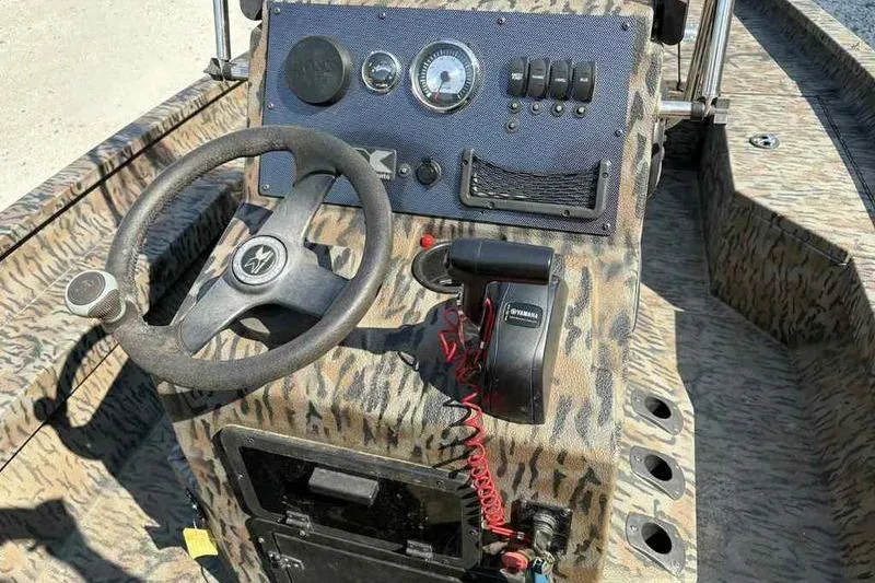 Slide: The Image of 2020 Xpress H20B Bay boat dashboard with steering wheel and controls. - 11