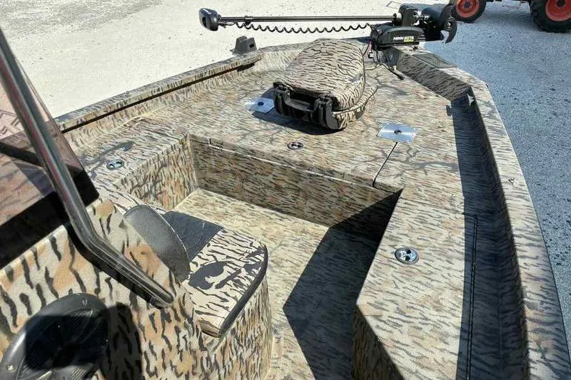 Slide: The Image of 2020 Xpress H20B Bay boat with camouflage design and trolling motor. - 12