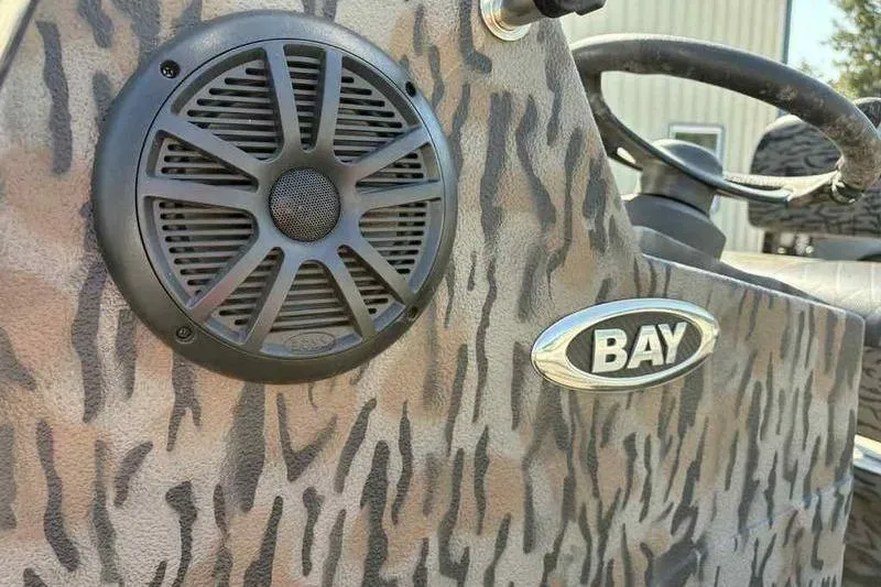 Slide: The Image of Camouflage-patterned Xpress H20B Bay boat interior with speaker, 2020 model. - 15