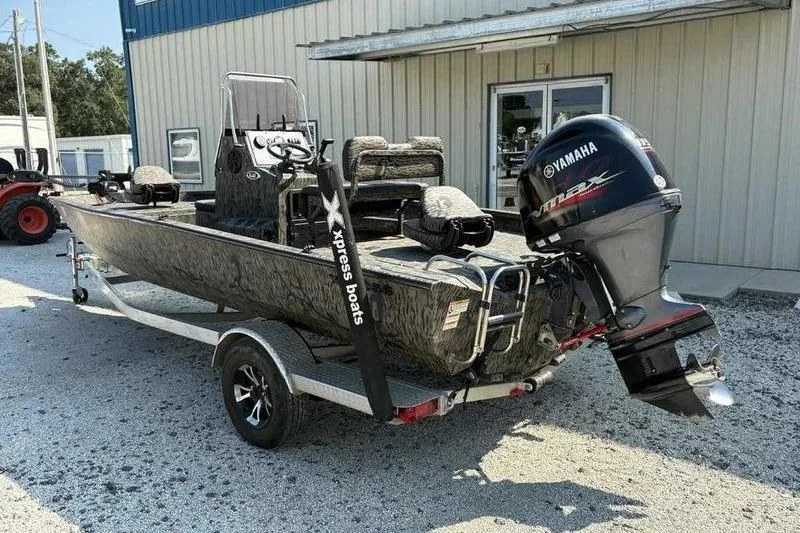 Slide: The Image of 2020 Xpress H20B Bay boat with Yamaha outboard motor on a trailer. - 8