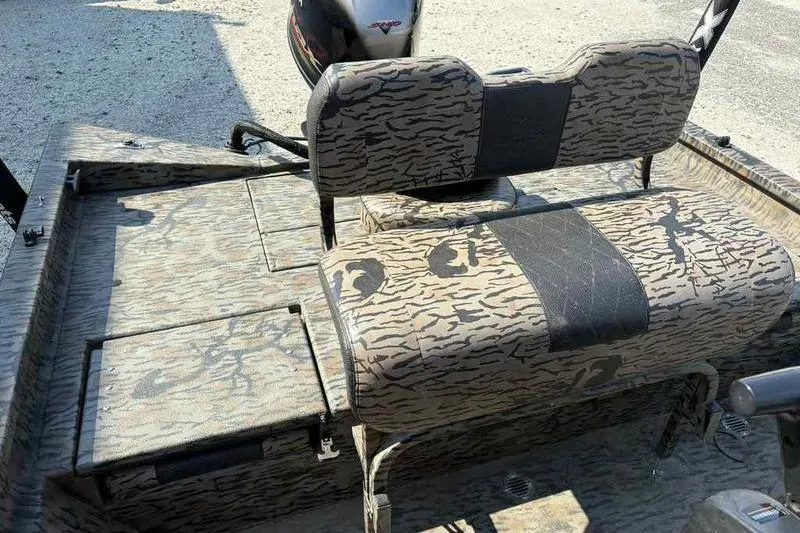 Slide: The Image of 2020 Xpress H20B Bay boat interior with camouflage seating and storage compartments. - 9